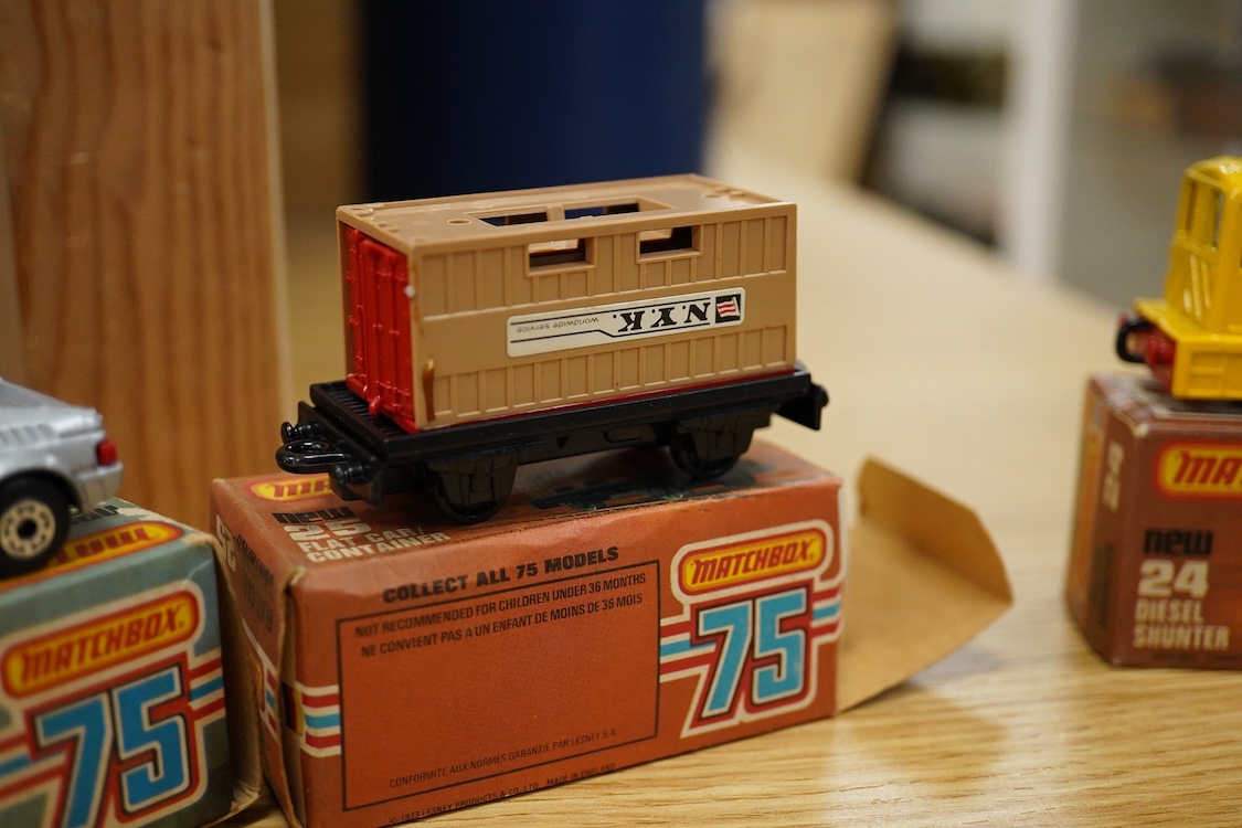 Twelve boxed Matchbox Superfast and Rola-matics 1-75 vehicles; VW Golf (7), petrol tanker (14), Badger (16), Blaze Buster (22), Atlas truck (23), diesel shunter (24), flat car with container (25), passenger coach (44), K